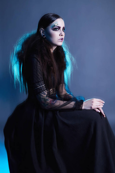 fashion witch woman with halloween make-up. halloween concept. mystic girl - Фото, изображение