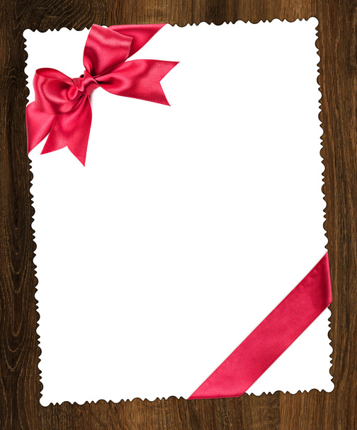 blank paper sheet with red bow - Фото, зображення