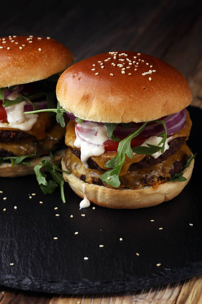 Tasty fresh meat burgers with salad and cheese. Homemade angus burger - Zdjęcie, obraz