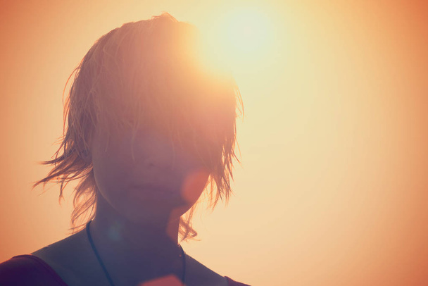 Silhouette of a blonde girl in the sunlight - Fotoğraf, Görsel