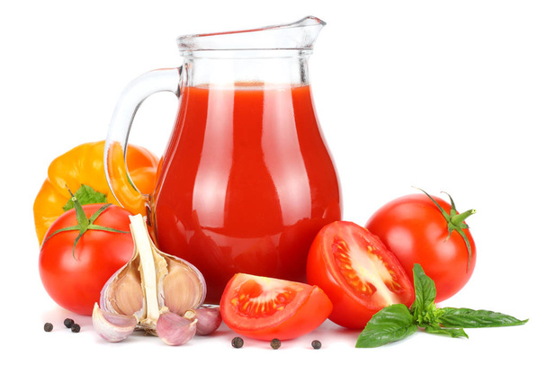 Tomato juice in glass jug with tomato, garlic, spices, and basil isolated on white background - Фото, зображення