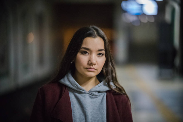 Nuori kaunis nainen odottaa junaa metroasemalla. Öitä
 - Valokuva, kuva