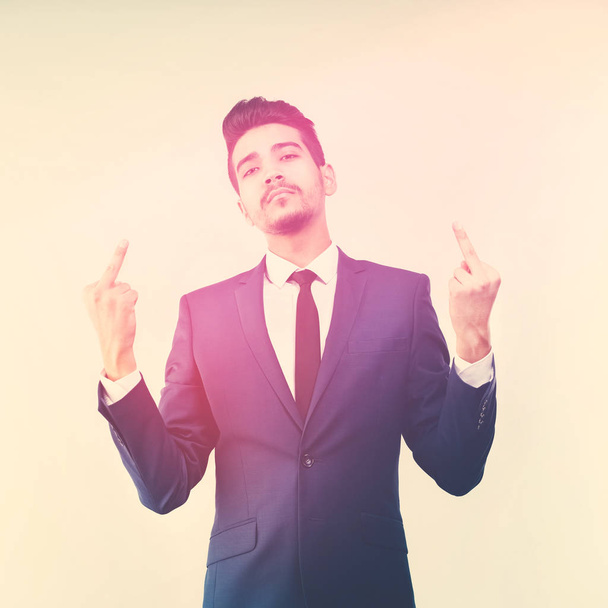 Young attractive man in a blue suit showing middle fingers. Toned - Valokuva, kuva