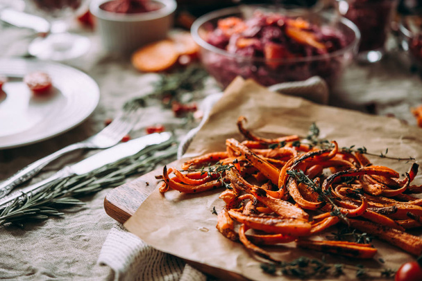 Roasted carrot. Autumn or winter dinner table, celebrating Christmas or New Year eve. Healthy modern vegetable dishes - Photo, Image