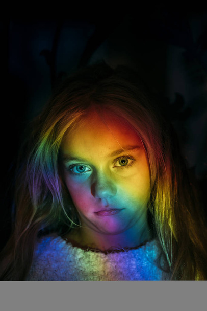 Small Girl portrait with blue eyes between color lights - Photo, Image