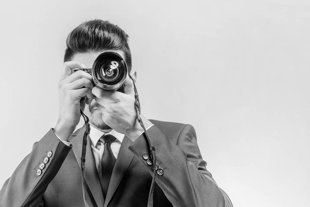 Young attractive man in a blue suit with a camera. Toned - Foto, immagini