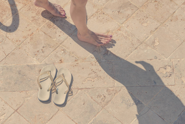 White sandals and female legs on the tile - Фото, зображення