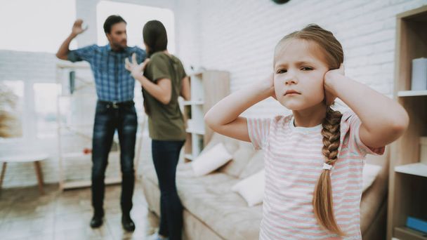 Child Closes Ears. Child and Quarreling Parents. Family Problems. Parents Scandal. Scared Child. Angry Person. Complicated Relationship. Family Quarrel. Bad Parents. Sufferings Children. Unhappy Child - Фото, изображение