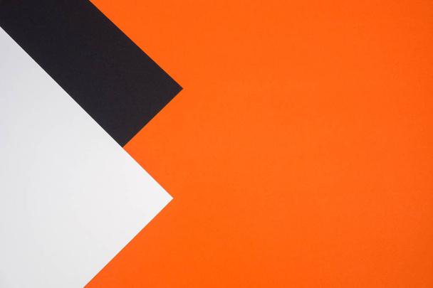 Black, orange and white color paper geometric flat lay background - Foto, afbeelding