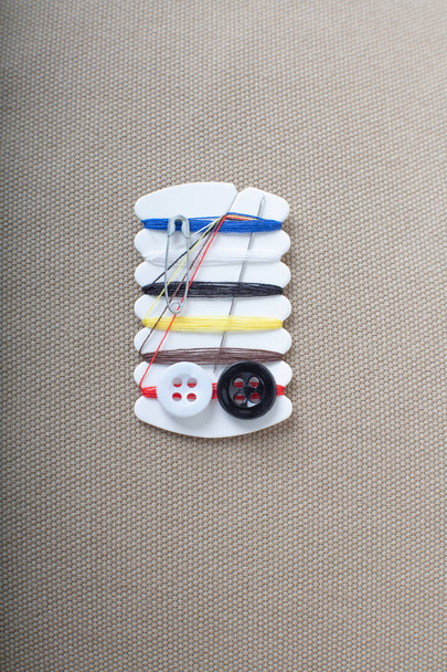 Small sewing kit against fabric background , top view image - 写真・画像