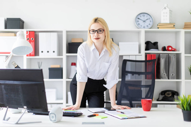 young businesswoman  standing in the office at the computer table.  - Photo, Image