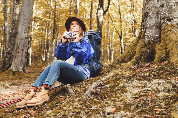 Young Pretty Woman With Walking Sticks In A Forest - Φωτογραφία, εικόνα