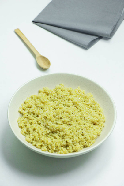 Cooked quinoa in white bowl on white background - Photo, Image