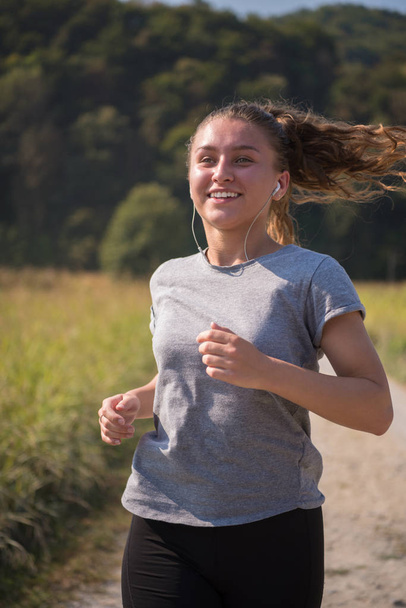 young female runner jogging in countryside - Fotoğraf, Görsel