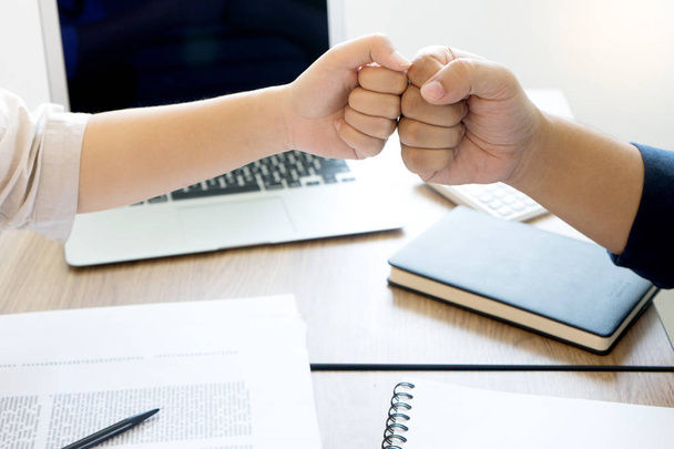 two business man woman use hand to fist bump for succes teamwork coporate with black computer screen with clipping path - Photo, Image