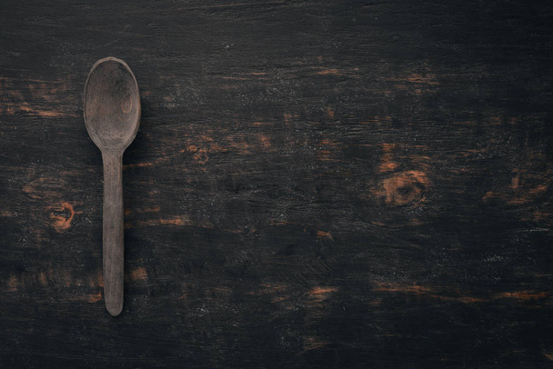 Wooden spoon Top view. On a wooden background. Free space for your text. - Foto, Bild