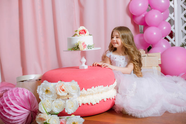 Little girl with blond long hair celebrate Happy Birthday Party with rose decor, balloons and cake - Fotografie, Obrázek