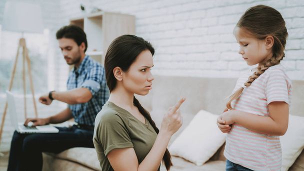 Mom Scolds Daughter. Family Problems. Scared Child. Complicated Relationship. Family Quarrel. Bad Parents. Sufferings Children. Man Screams Woman. Woman Arguing with Man. Father Working on Laptop. - 写真・画像