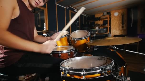 Drummer passionately plays music on wet drums in studio - Footage, Video
