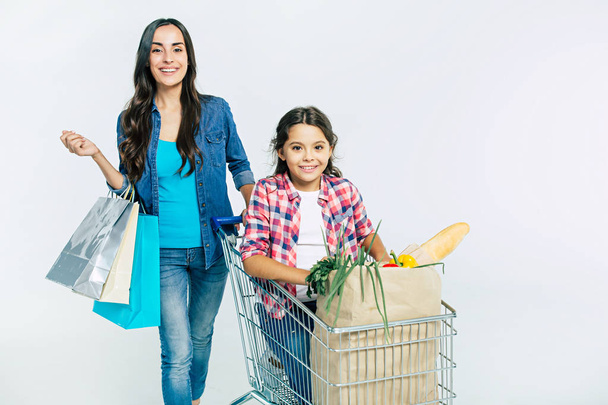 Mother and daughter with shopping bags on white background, shopping concept - Fotoğraf, Görsel