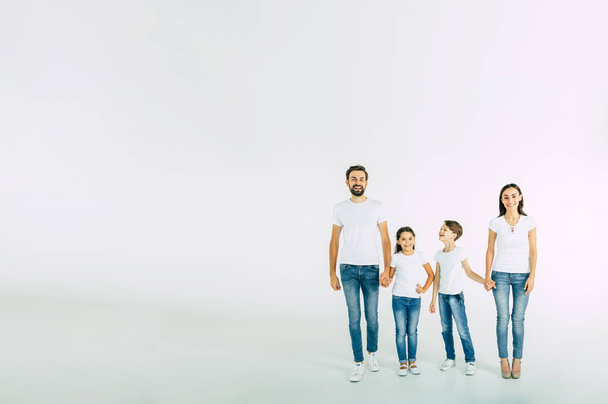 Group portrait of young caucasian family with son and daughter on white background - Valokuva, kuva