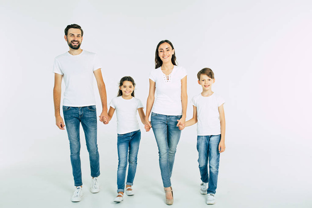 Group portrait of young caucasian family with son and daughter on white background - Fotó, kép