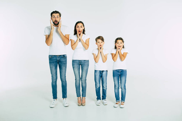 Group portrait of young caucasian family with son and daughter on white background - Foto, immagini