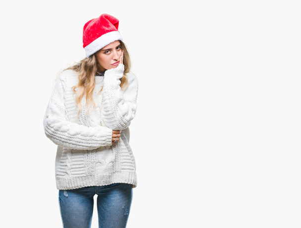 Beautiful young blonde woman wearing christmas hat over isolated background thinking looking tired and bored with depression problems with crossed arms. - Photo, Image