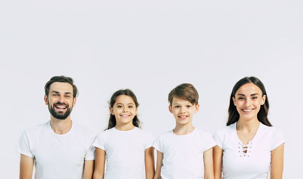 Group portrait of young caucasian family with son and daughter on white background - Φωτογραφία, εικόνα