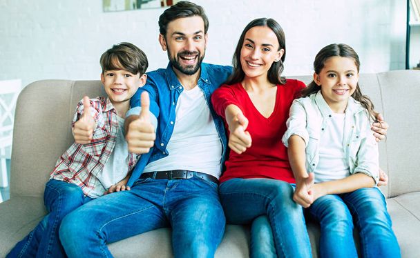 Young family spending happy time at home  - Foto, Bild