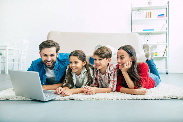 Young family using laptop and spending time at home - Foto, Imagen