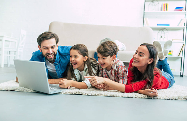 Young family using laptop and spending time at home - Photo, Image