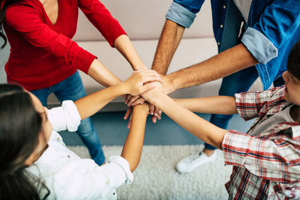 Friendly young family gathering hands together in circle  - Φωτογραφία, εικόνα