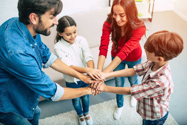 Friendly young family gathering hands together in circle  - Foto, immagini