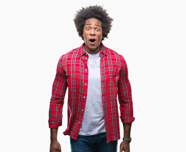 Afro american man over isolated background afraid and shocked with surprise expression, fear and excited face. - Photo, Image