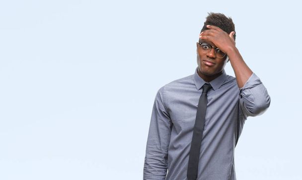 Young african american business man over isolated background surprised with hand on head for mistake, remember error. Forgot, bad memory concept. - Photo, Image