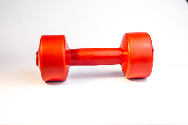 Close up view of red dumbbell on white background - Фото, изображение