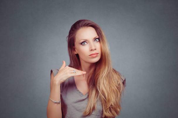 Angry girl woman with long hair and gray shirt, cut it out stop it sign and gesture concept isolated over on gray grey studio wall Background. Negative face expression emotion body language reaction - Foto, afbeelding