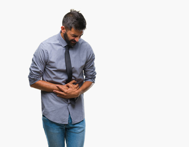 Adult hispanic business man over isolated background with hand on stomach because nausea, painful disease feeling unwell. Ache concept. - Photo, image