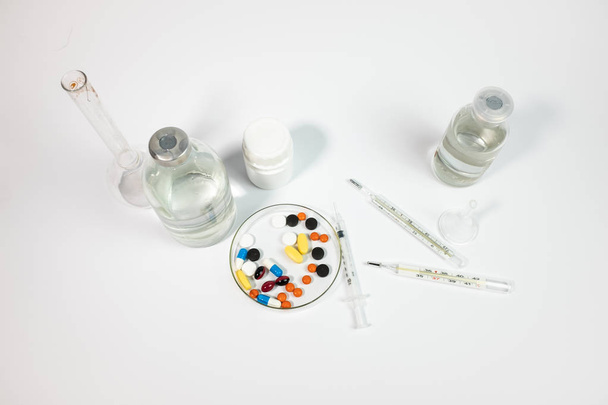 Variety medicines and syringe, isolated on white background  - Photo, image