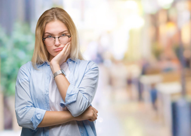 Young caucasian business woman wearing glasses over isolated background thinking looking tired and bored with depression problems with crossed arms. - Фото, зображення