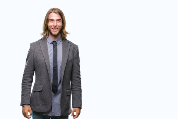 Young handsome business man with long hair over isolated background with a happy and cool smile on face. Lucky person. - Photo, Image