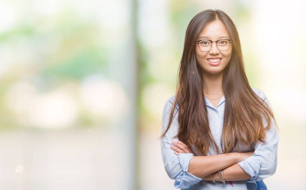 Fiatal ázsiai üzleti nő visel szemüveget, mint elszigetelt háttér boldog arca mosolygós, átlépte a fegyverek néz a kamerába. Pozitív embernek. - Fotó, kép