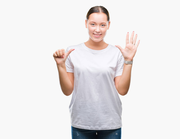 Young beautiful caucasian woman over isolated background showing and pointing up with fingers number six while smiling confident and happy. - Foto, afbeelding