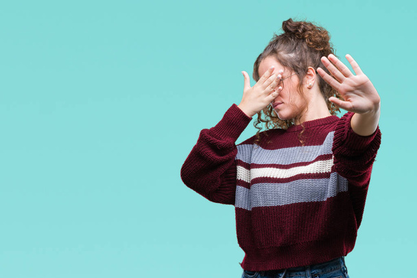 Beautiful brunette curly hair young girl wearing glasses over isolated background covering eyes with hands and doing stop gesture with sad and fear expression. Embarrassed and negative concept. - Photo, Image