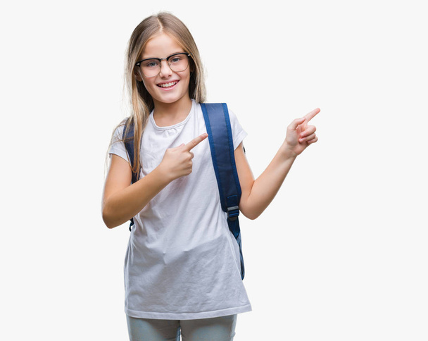 Young beautiful smart student girl wearing backpack over isolated background smiling and looking at the camera pointing with two hands and fingers to the side. - Foto, Bild