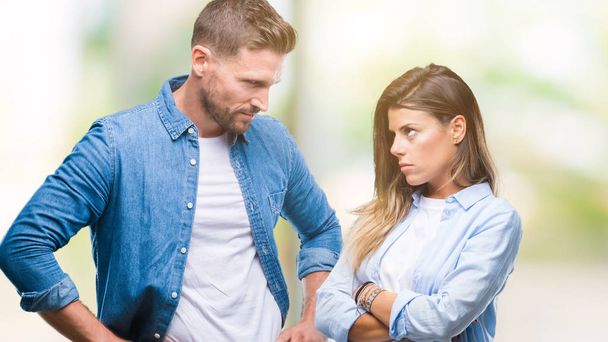 Young couple in love over isolated background skeptic and nervous, disapproving expression on face with crossed arms. Negative person. - Photo, Image
