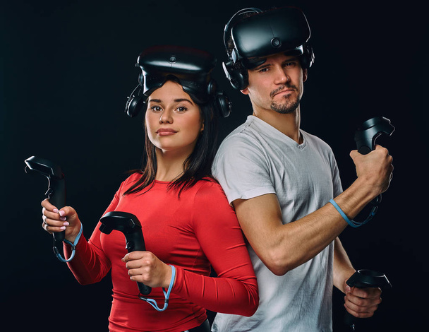 Young caucasian couple with VR headsets and controllers. - Photo, Image