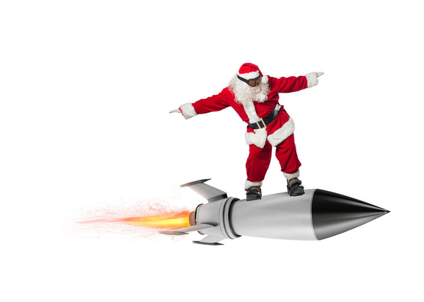 Szybka dostawa prezenty świąteczne. Santa Claus gotowy do lotu rakietą na białym tle - Zdjęcie, obraz