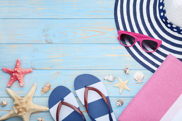 Summer accessories with seashells and sunglasses on wooden table - 写真・画像